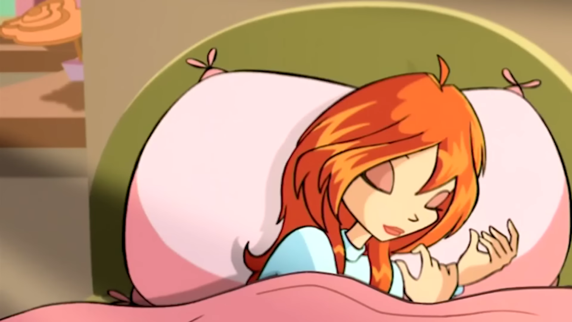Bloom is laying in bed, the shelf with a flower is to the left of it