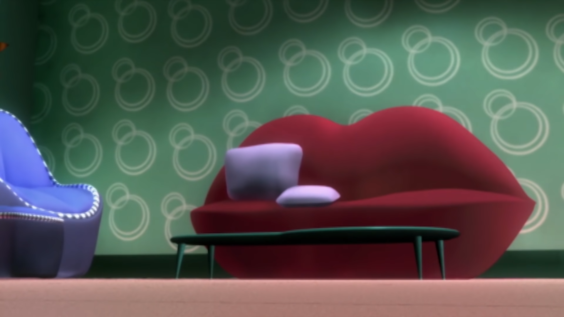 An image of the red lips-shaped sofa from the Bratz TV show, with two lilac pillows on its left side